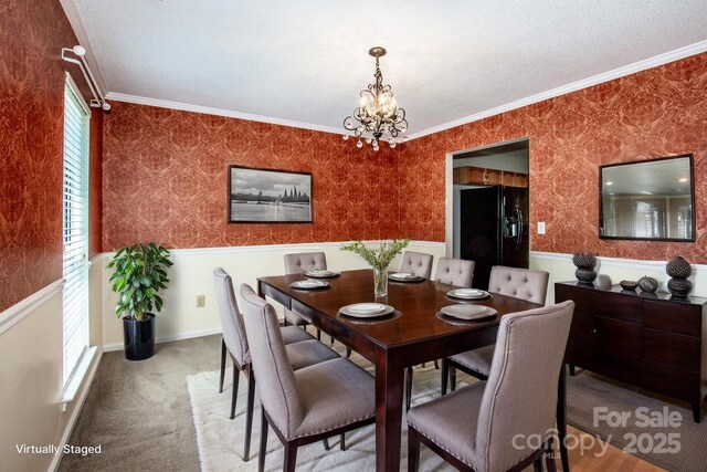 292 Rose St, Mooresville, NC 28117 - dining area featuring a wainscoted wall, wallpapered walls, a chandelier, crown molding, and carpet
