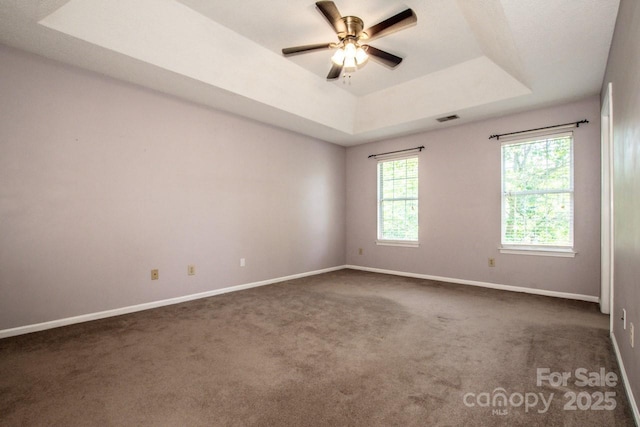 292 Rose St, Mooresville, NC 28117 - carpeted spare room with a tray ceiling, baseboards, and a ceiling fan
