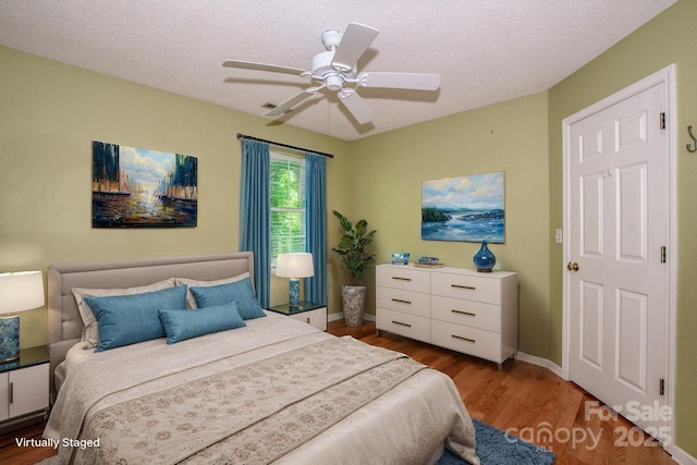 292 Rose St, Mooresville, NC 28117 - bedroom with wood finished floors, baseboards, a ceiling fan, and a textured ceiling