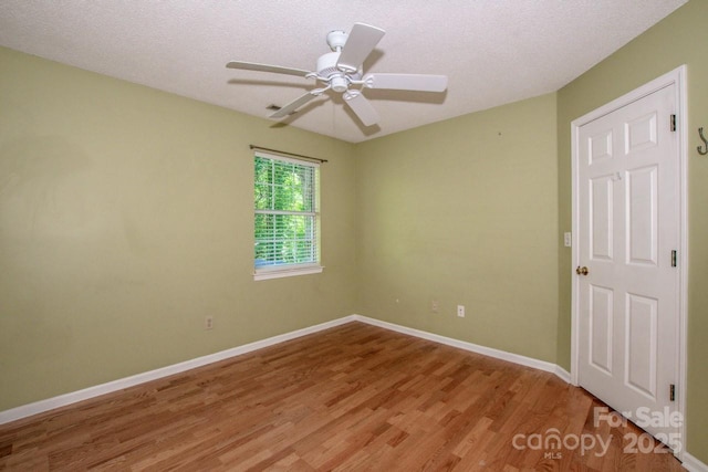 292 Rose St, Mooresville, NC 28117 - spare room with light wood-style flooring, baseboards, ceiling fan, and a textured ceiling