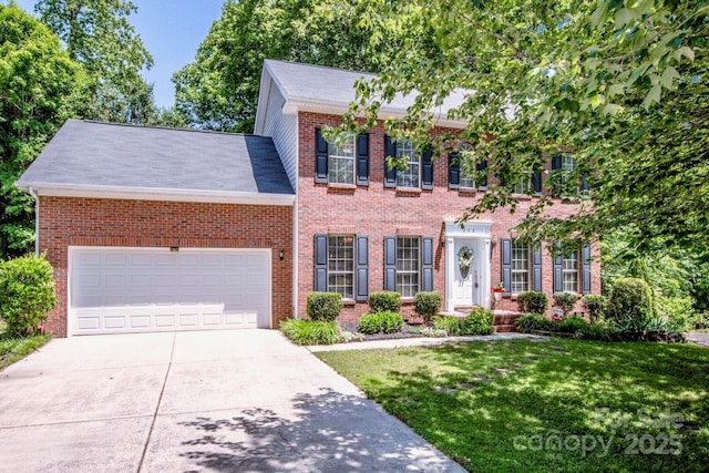 292 Rose St, Mooresville, NC 28117 - colonial home featuring a front lawn, brick siding, driveway, and a garage