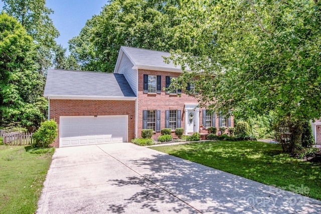 292 Rose St, Mooresville, NC 28117 - colonial house with brick siding, concrete driveway, and a garage