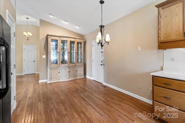 305 Kyfields, Weaverville, NC 28787 - unfurnished dining area with a chandelier, hardwood / wood-style floors, baseboards, and lofted ceiling