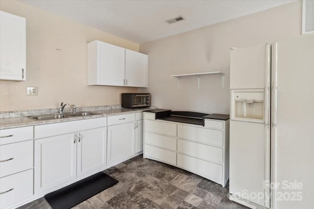 305 Kyfields, Weaverville, NC 28787 - kitchen featuring white refrigerator with ice dispenser, a sink, open shelves, white cabinetry, and a textured ceiling