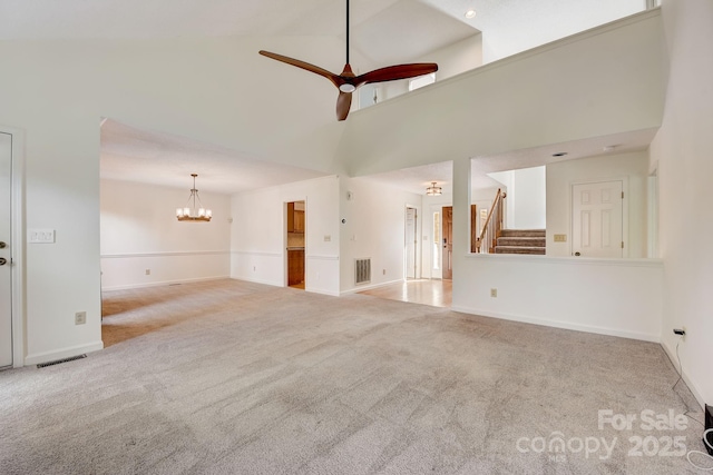 5108 Tedorill Ln, Charlotte, NC 28226 - unfurnished living room featuring carpet floors, stairs, ceiling fan, a towering ceiling, and a chandelier