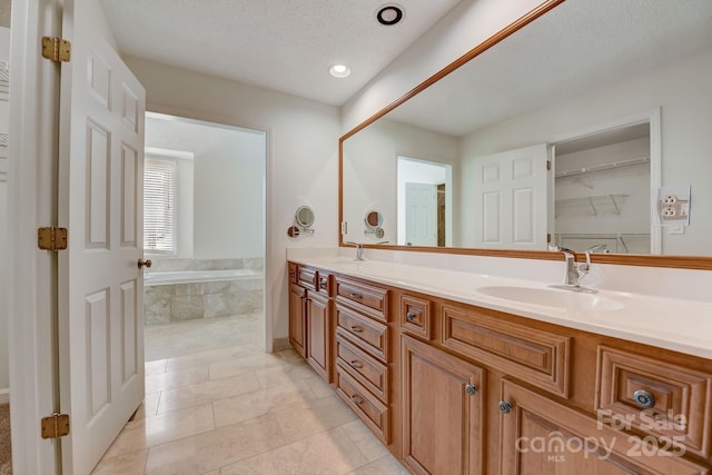 5108 Tedorill Ln, Charlotte, NC 28226 - full bathroom featuring double vanity, a bath, tile patterned flooring, a textured ceiling, and recessed lighting