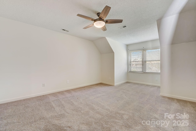 5108 Tedorill Ln, Charlotte, NC 28226 - additional living space with a textured ceiling, a ceiling fan, light carpet, lofted ceiling, and baseboards