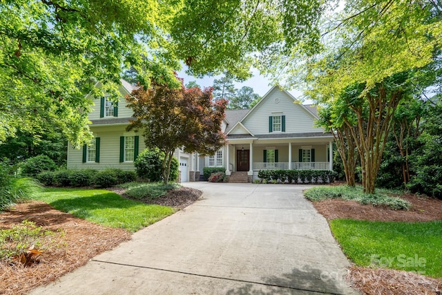 154 Pattersons Brg, New London, NC 28127 - view of front of property with covered porch, concrete driveway, and a front lawn