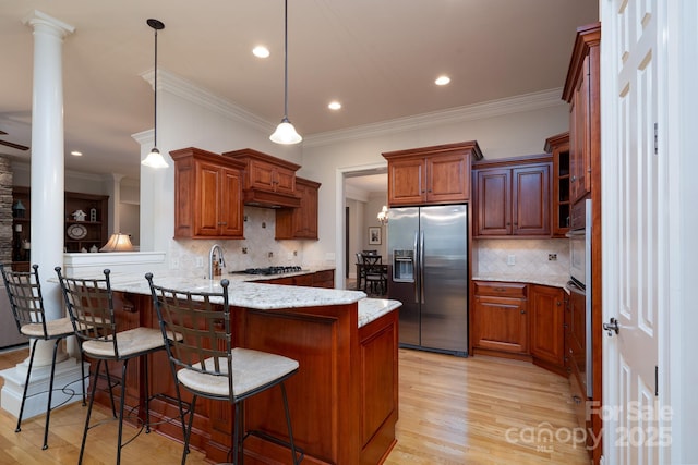 154 Pattersons Brg, New London, NC 28127 - kitchen with stainless steel appliances, a peninsula, ornamental molding, light wood-style floors, and decorative backsplash
