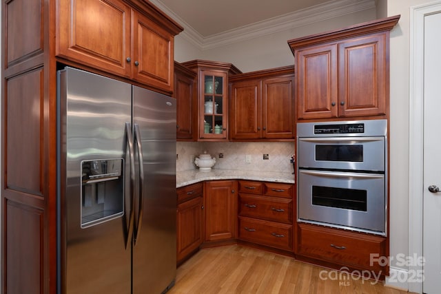 154 Pattersons Brg, New London, NC 28127 - kitchen featuring stainless steel appliances, light wood-style floors, ornamental molding, light stone countertops, and glass insert cabinets