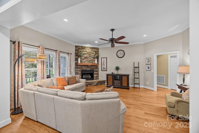 living area featuring recessed lighting, baseboards, crown molding, ceiling fan, and a fireplace