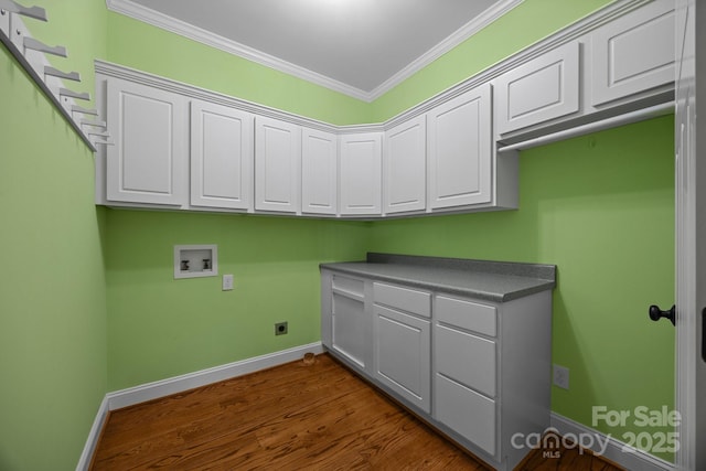 clothes washing area with cabinet space, washer hookup, crown molding, baseboards, and dark wood-type flooring