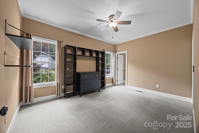 unfurnished bedroom featuring baseboards, ornamental molding, carpet, and ceiling fan