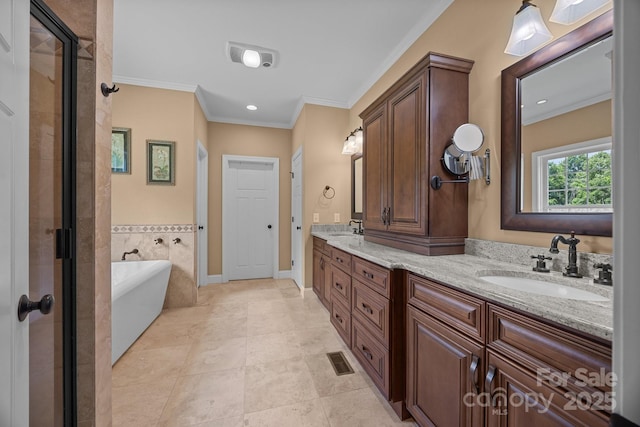 bathroom featuring ornamental molding, a freestanding bath, a shower stall, double vanity, and recessed lighting