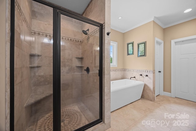 bathroom with a freestanding bath, a stall shower, ornamental molding, tile walls, and recessed lighting