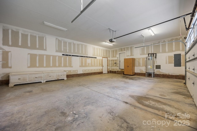 garage featuring electric panel, a garage door opener, and water heater
