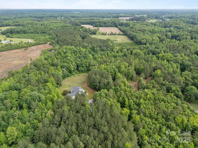aerial view of property's location with a heavily wooded area