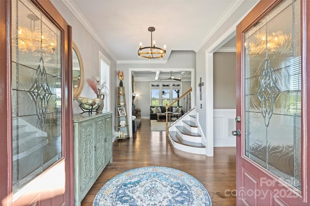 4941 Campobello Dr, Monroe, NC 28110 - foyer entrance featuring a chandelier, dark wood-style floors, ornamental molding, a wainscoted wall, and stairway