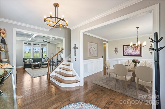 4941 Campobello Dr, Monroe, NC 28110 - dining space featuring a chandelier, crown molding, wood finished floors, stairway, and wainscoting