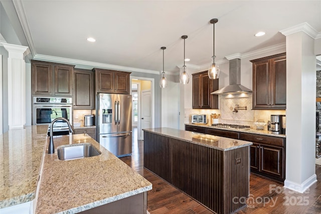 4941 Campobello Dr, Monroe, NC 28110 - kitchen with stainless steel appliances, a center island with sink, wall chimney exhaust hood, a sink, and dark brown cabinets