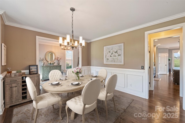 4941 Campobello Dr, Monroe, NC 28110 - dining space with a chandelier, crown molding, dark wood-style flooring, and wainscoting
