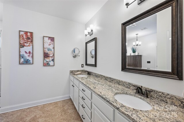 4941 Campobello Dr, Monroe, NC 28110 - bathroom featuring baseboards, double vanity, and a chandelier