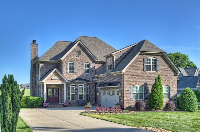 4941 Campobello Dr, Monroe, NC 28110 - view of front of property with concrete driveway, brick siding, a chimney, and a garage