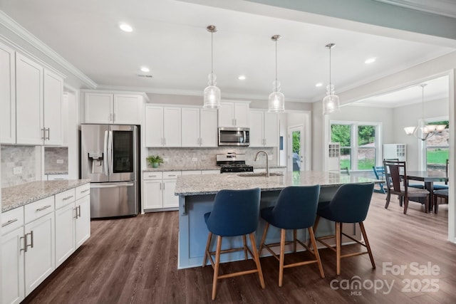 3218 Gilroy Dr, Fort Mill, SC 29707 - kitchen with stainless steel appliances, a sink, white cabinetry, dark wood-style flooring, and ornamental molding