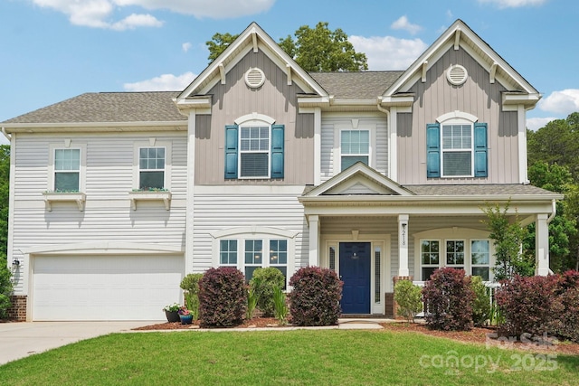 3218 Gilroy Dr, Fort Mill, SC 29707 - view of front facade with board and batten siding, an attached garage, a front yard, concrete driveway, and a shingled roof