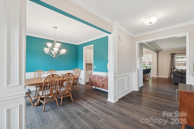 3218 Gilroy Dr, Fort Mill, SC 29707 - dining area featuring dark wood-style floors, a chandelier, crown molding, and wainscoting