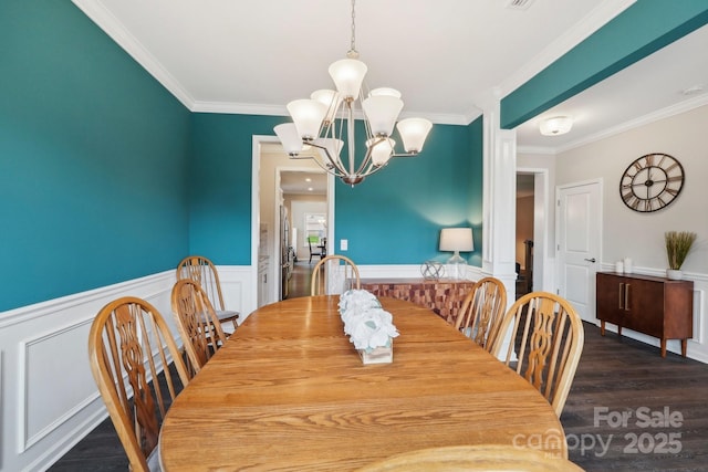 3218 Gilroy Dr, Fort Mill, SC 29707 - dining area featuring crown molding, a chandelier, a wainscoted wall, dark wood-style flooring, and a decorative wall