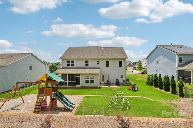 3218 Gilroy Dr, Fort Mill, SC 29707 - back of property with a playground, a sunroom, a lawn, and a patio