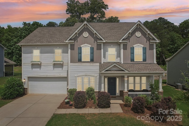 3218 Gilroy Dr, Fort Mill, SC 29707 - view of front of property featuring covered porch, an attached garage, concrete driveway, board and batten siding, and roof with shingles