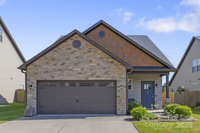 19 Wetland Way, Arden, NC 28704 - craftsman-style house with stone siding, concrete driveway, a garage, and fence