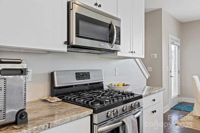 19 Wetland Way, Arden, NC 28704 - kitchen with appliances with stainless steel finishes, white cabinets, dark wood finished floors, and baseboards
