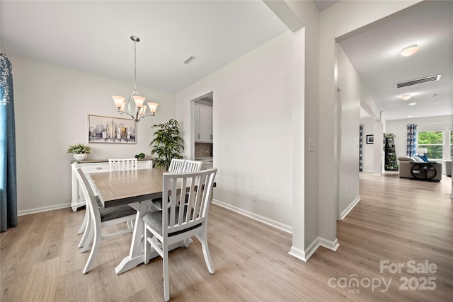 1918 Thoreau Way, York, SC 29745 - dining room with light wood finished floors, a chandelier, and baseboards