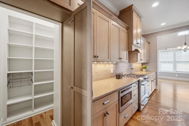 kitchen with stainless steel appliances, decorative backsplash, light wood-style floors, ornamental molding, and light stone counters
