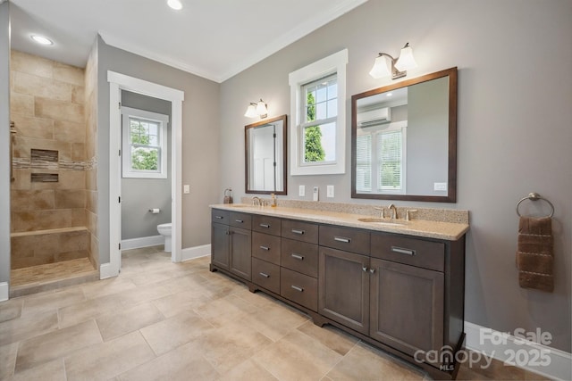 bathroom featuring a wall mounted air conditioner, plenty of natural light, a tile shower, baseboards, and crown molding