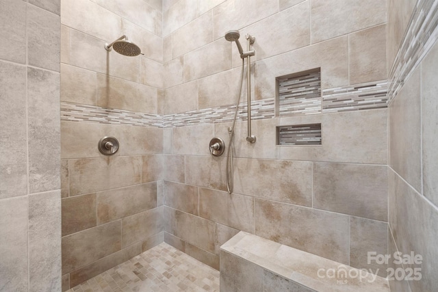 full bath featuring a tile shower