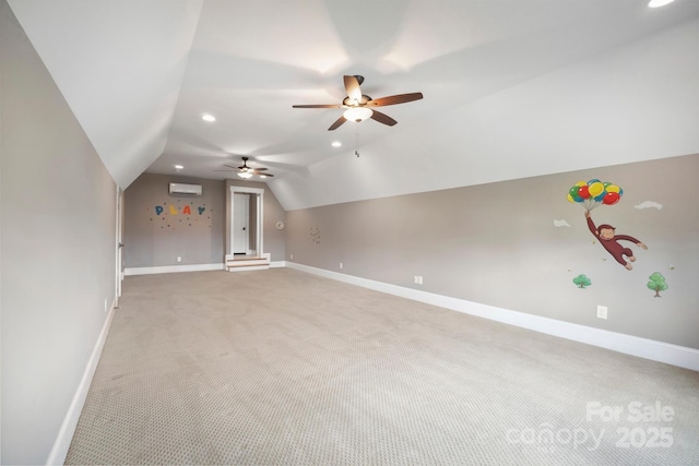bonus room with light carpet, vaulted ceiling, a ceiling fan, baseboards, and a wall mounted air conditioner