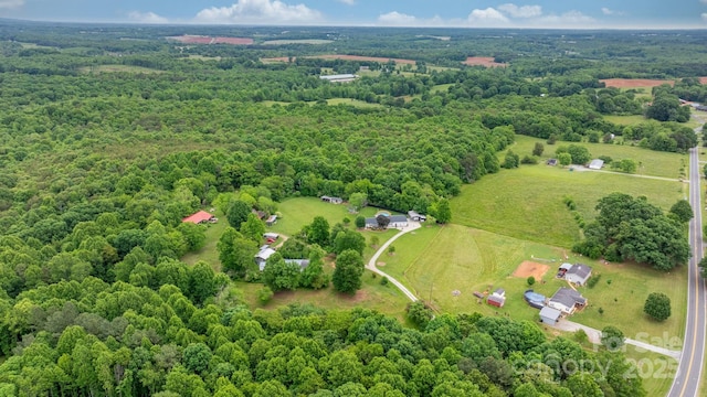 aerial view of sparsely populated area featuring a forest