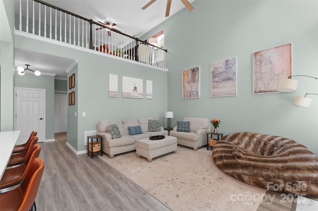 8 Secrest Dr, Arden, NC 28704 - living room featuring a towering ceiling, wood finished floors, ceiling fan, baseboards, and crown molding