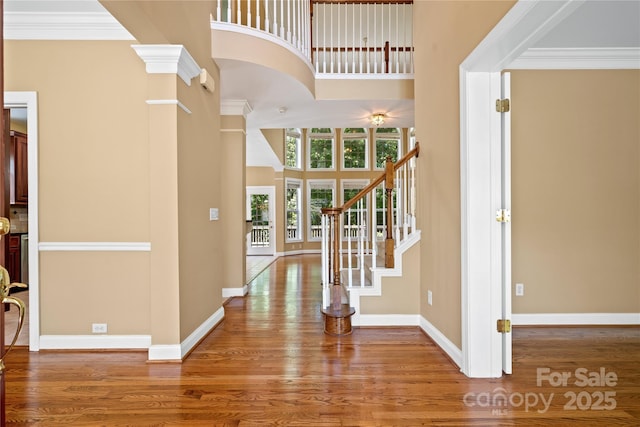 10616 Back Ridge Rd, Charlotte, NC 28277 - foyer entrance featuring wood finished floors, a high ceiling, baseboards, stairs, and ornamental molding