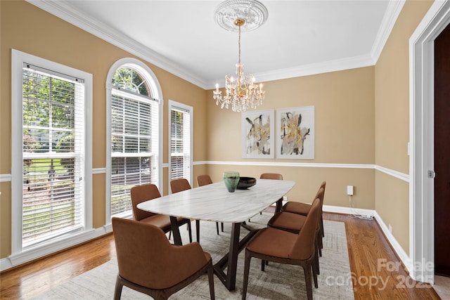 10616 Back Ridge Rd, Charlotte, NC 28277 - dining space with a chandelier, ornamental molding, wood finished floors, and baseboards