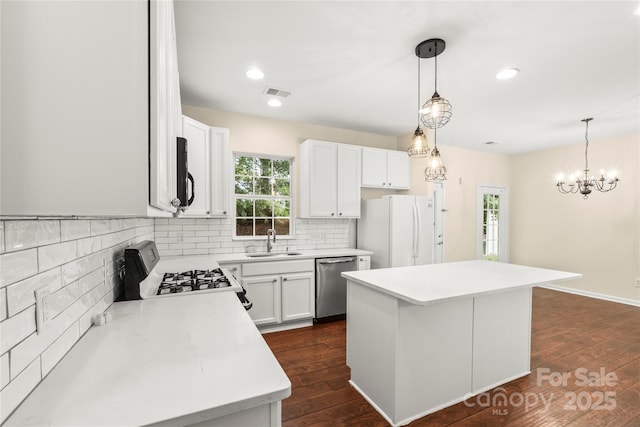 9430 Duckhorn Dr, Charlotte, NC 28277 - kitchen featuring white appliances, a center island, decorative backsplash, healthy amount of natural light, and recessed lighting