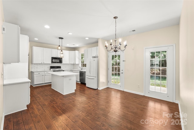 9430 Duckhorn Dr, Charlotte, NC 28277 - kitchen with black microwave, stainless steel dishwasher, freestanding refrigerator, a chandelier, and dark wood-style flooring