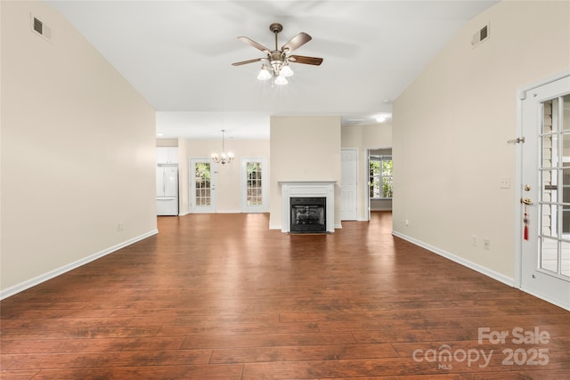 9430 Duckhorn Dr, Charlotte, NC 28277 - unfurnished living room featuring ceiling fan, dark wood-style floors, a chandelier, and a fireplace