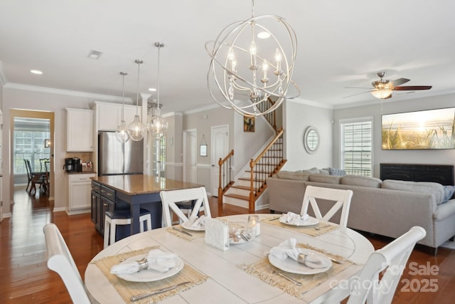 10401 Royal Winchester Dr, Charlotte, NC 28277 - dining room featuring a chandelier, stairs, crown molding, wood finished floors, and ceiling fan