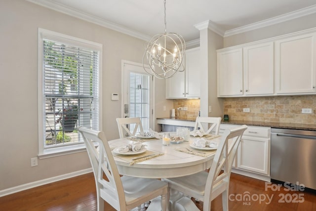 10401 Royal Winchester Dr, Charlotte, NC 28277 - dining room featuring a chandelier, dark wood-style flooring, healthy amount of natural light, ornamental molding, and baseboards