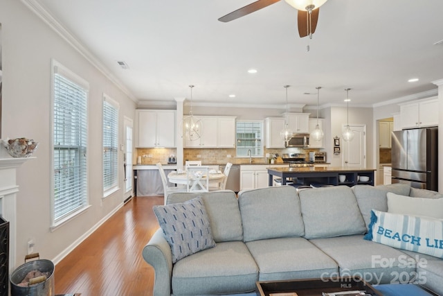10401 Royal Winchester Dr, Charlotte, NC 28277 - living area featuring recessed lighting, a ceiling fan, crown molding, light wood finished floors, and baseboards